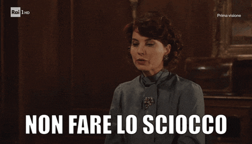 a woman says " non fare lo sciocco " in front of a television screen