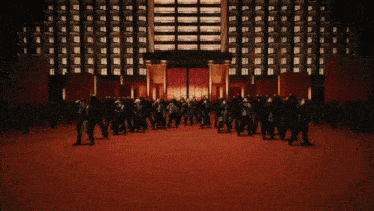 a large group of people dancing in front of a building