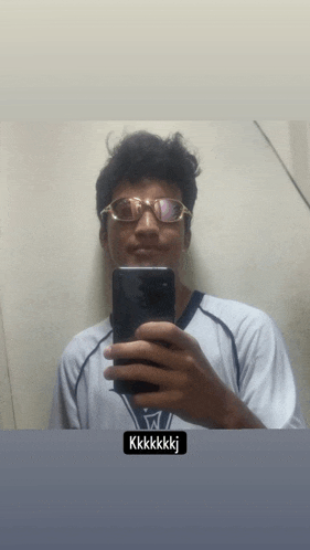 a man wearing glasses takes a picture of himself with the words kkkkkkj below him