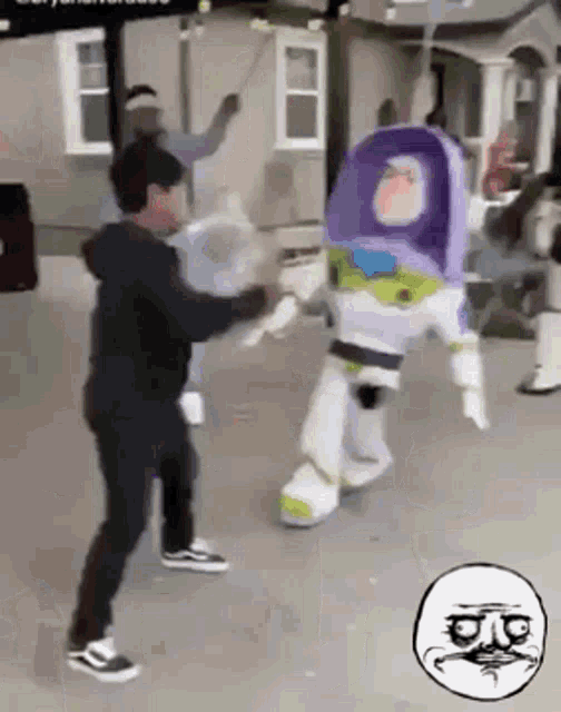 a man standing next to a toy story buzz lightyear mascot .