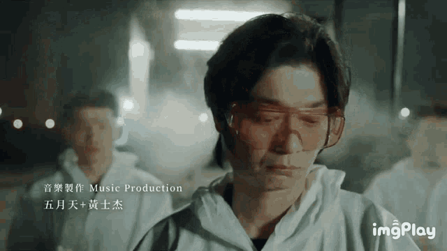 a man wearing glasses and a white jacket is being edited by music production
