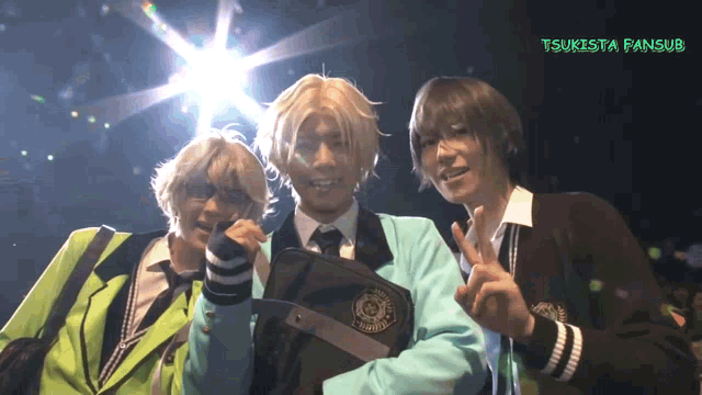 three people posing for a picture with tsukista fansub written in green