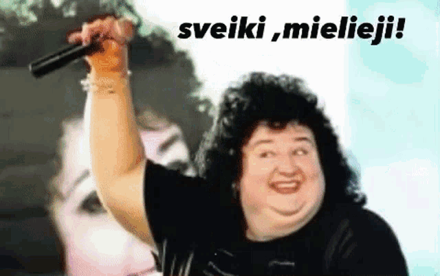 a fat woman is holding a microphone in front of a screen that says ' sveiki , mielieji ! '