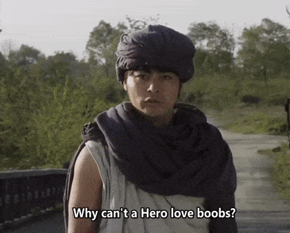 a man with a scarf around his neck says why can t a hero love boobs