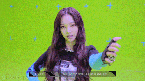 a girl with long hair is waving her hand in front of a green screen that says gifsaespa on it