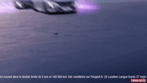 a blurred image of a car with the words " thinkjules " at the bottom