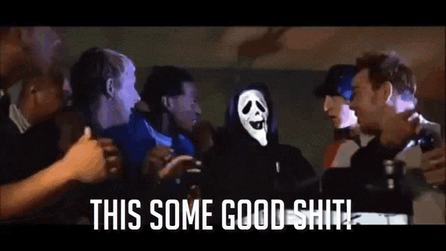 a group of people are gathered around a man with a scream mask on his face