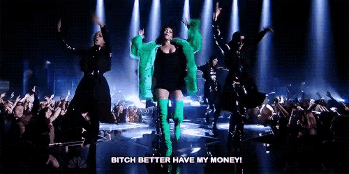 a woman in a green fur coat and green boots is dancing on a stage .