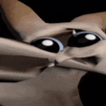 a close up of a cartoon cat 's face with big eyes .