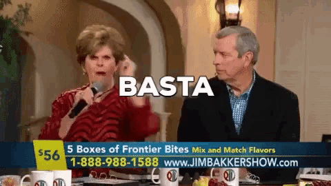 a man and a woman are sitting at a table with the word basta on the screen