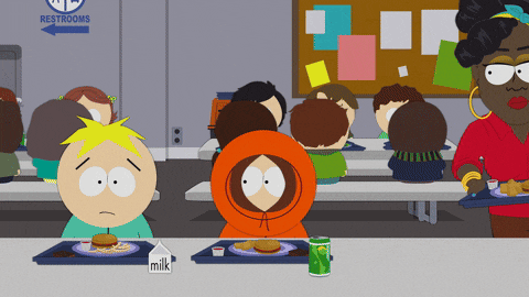 a group of cartoon characters are sitting at a table with a sign that says restrooms in the background