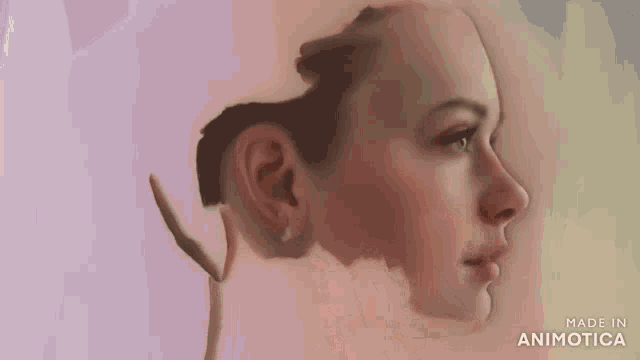 a close up of a person painting a woman 's face with a brush