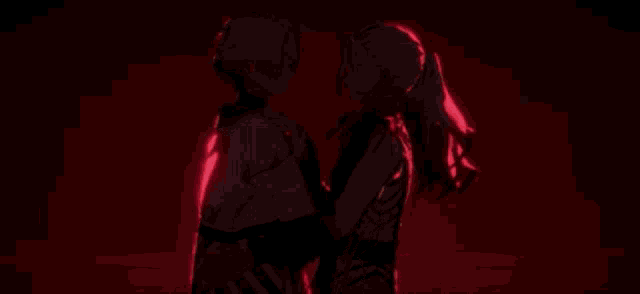 a couple of anime characters standing next to each other in front of a heart .