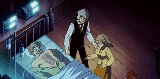 a man is laying in a hospital bed with a woman and a boy standing around him
