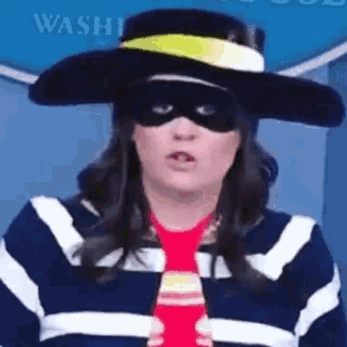 a woman wearing a hat , mask , and tie .