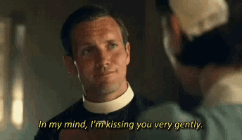 a man in a priest 's collar is talking to another man in a hospital .