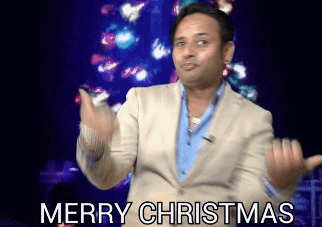 a man in a suit and blue shirt says merry christmas