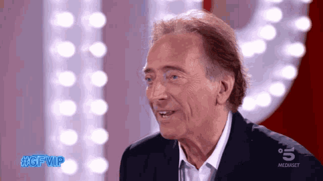 a man in a suit and white shirt is on a tv show called #gfvip