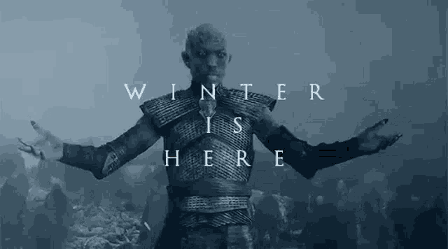 a man in armor is standing in front of a crowd of people with his arms outstretched and the words `` winter is here '' .
