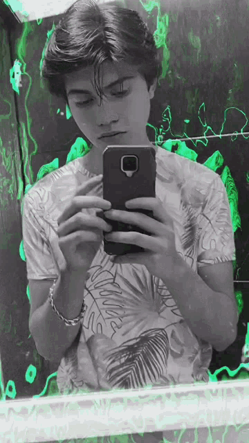 a young man is taking a selfie in front of a mirror