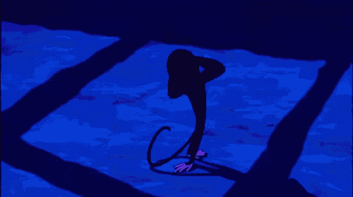 a cartoon monkey with big eyes is holding a rope in a dark room .