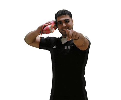 a man wearing a black shirt that says new balance is pointing at the camera