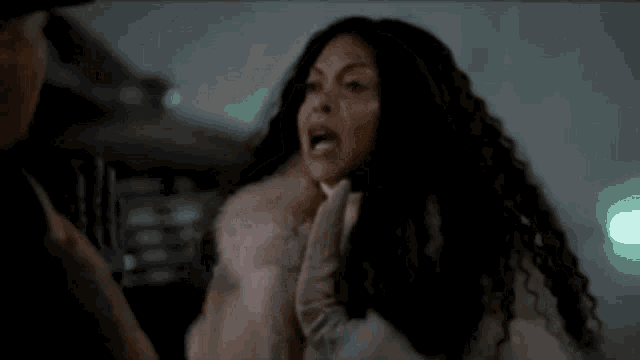 a woman in a fur coat is screaming at a man in a suit .