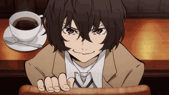 a man sitting at a table with a cup of coffee