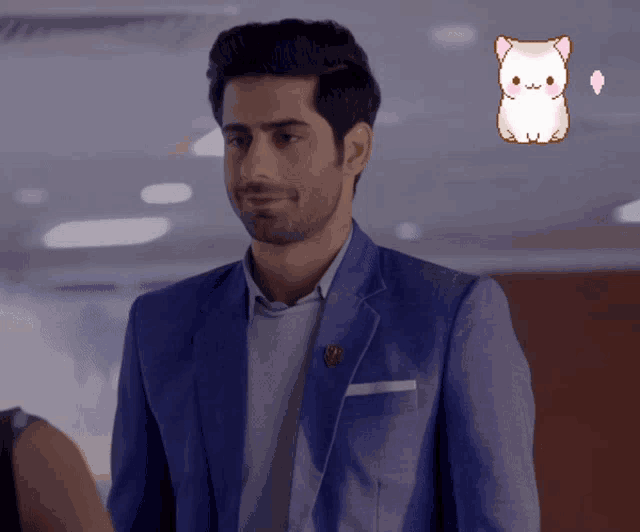a man in a blue suit has a sticker of a cat behind him