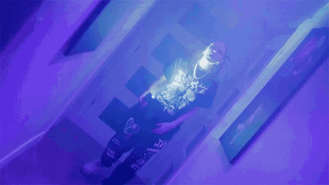 a person wearing a black shirt that says ambush