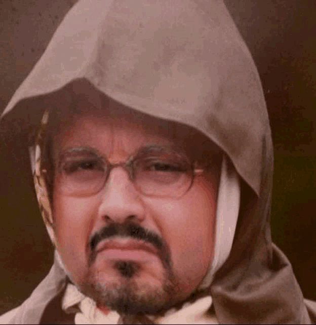 a man with glasses and a beard wearing a hooded jacket
