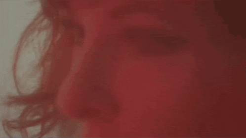 a close up of a person 's face with red hair and a white background .