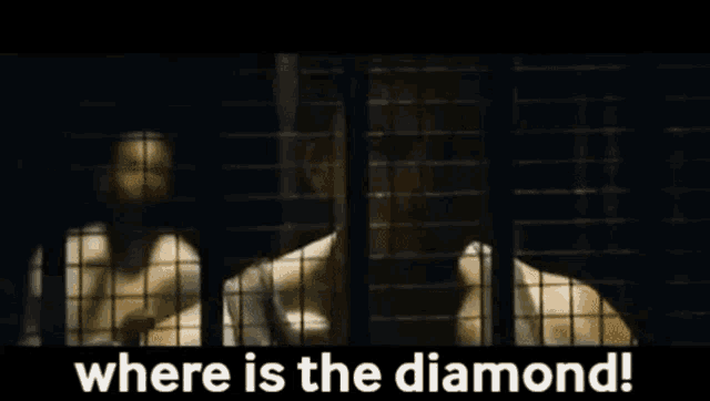 a man is behind bars in a cell with the words `` where is the diamond '' written above him .
