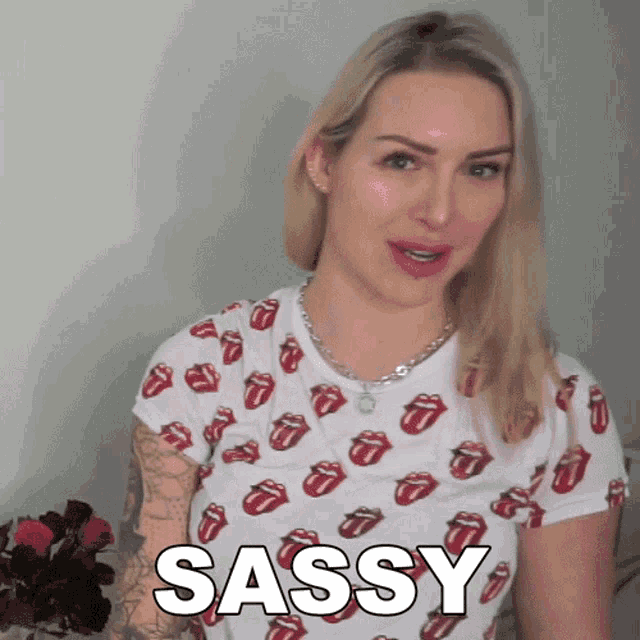 a woman wearing a rolling stones t-shirt says " sassy "