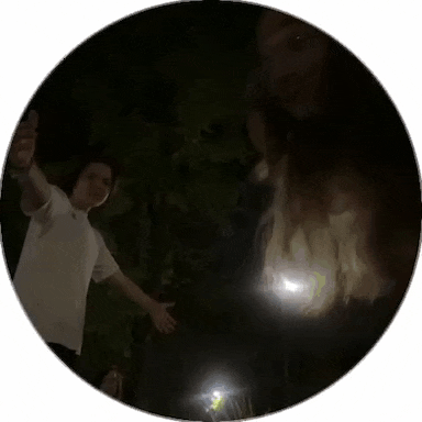 a man in a white shirt is standing in a dark circle with his arms outstretched