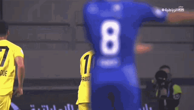 a soccer player in a yellow jersey with the number 10 on it