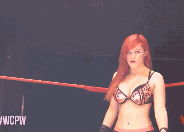 a woman in a bikini is standing in a wrestling ring with #wcpw on the bottom