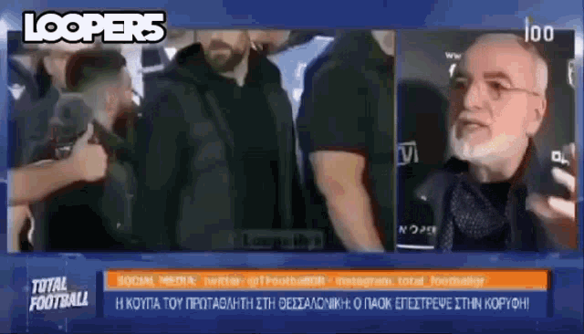 a man with a beard and glasses is talking to a group of people on a television screen .