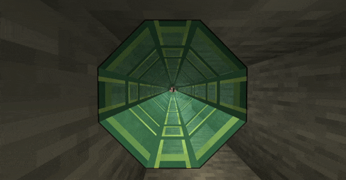 a very long green tunnel with a red light at the end of it