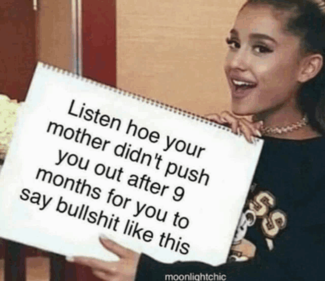 a woman is holding a sign that says listen hoe your mother did n't push you out after 9 months for you to say bullshit