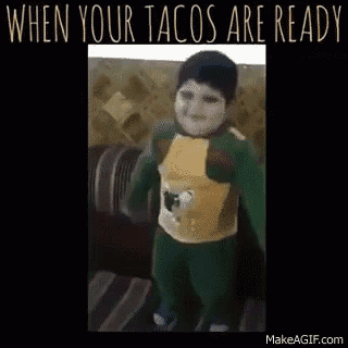 a little boy is dancing on a couch with the words when your tacos are ready on the bottom .