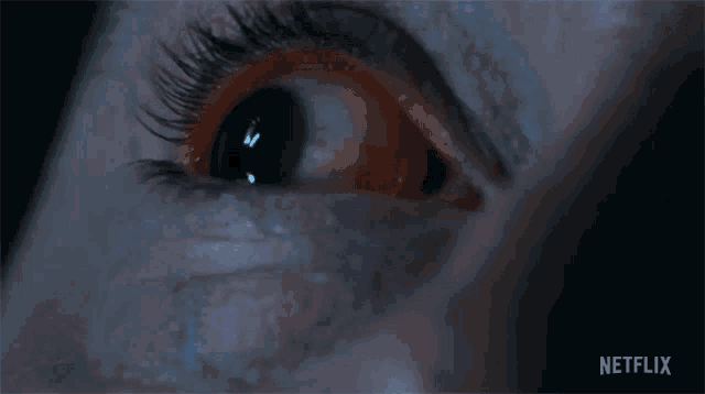 a close up of a woman 's eye with netflix written on the bottom right