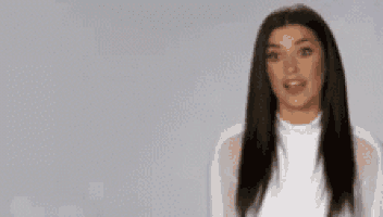a woman is standing in front of a sign that says ' i wanna know who you 're going with '