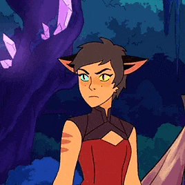 catra from she ra and the princesses of power is standing in a forest holding a sword .