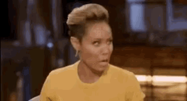 a woman in a yellow t-shirt is making a funny face .