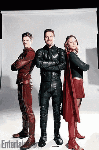 a man in a leather jacket is standing next to two other people