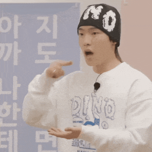 a man wearing a beanie and a sweatshirt that says dino