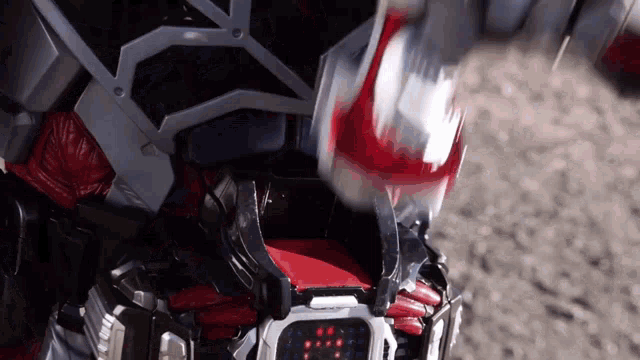 a close up of a person wearing a robot costume with a red belt