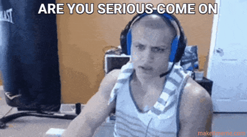a man wearing headphones is sitting in front of a boxing bag and says are you serious come on .