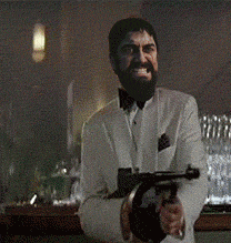a man with a beard is holding a gun in a bar